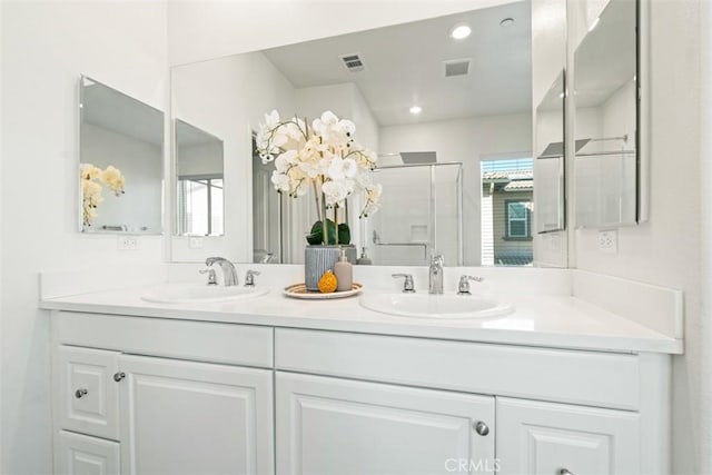 bathroom featuring vanity and an enclosed shower