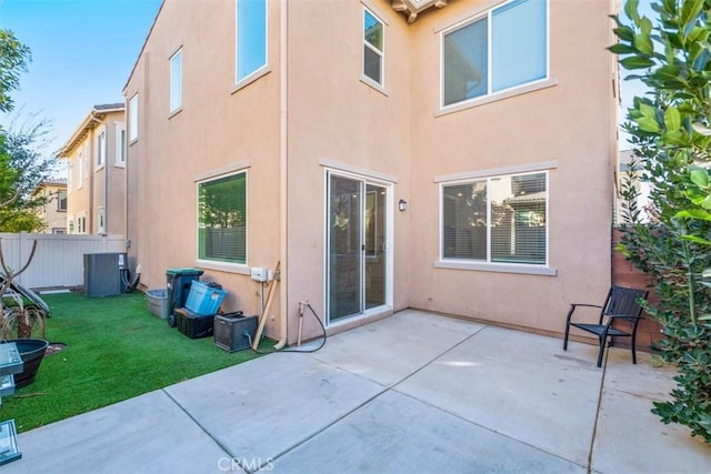 rear view of house with a lawn and a patio area