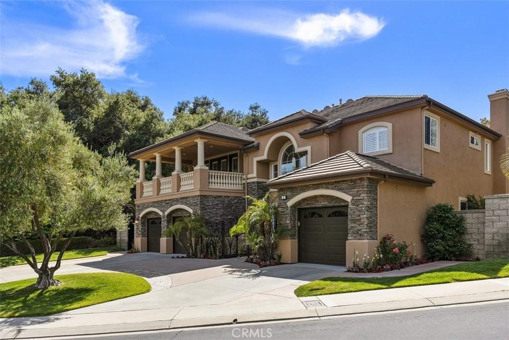 mediterranean / spanish-style house featuring a balcony and a garage