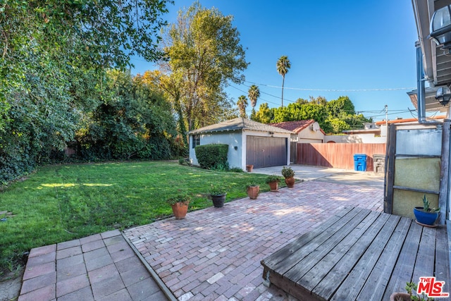 view of patio / terrace featuring an outbuilding and a garage