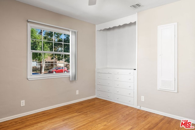 unfurnished bedroom with ceiling fan and light hardwood / wood-style floors