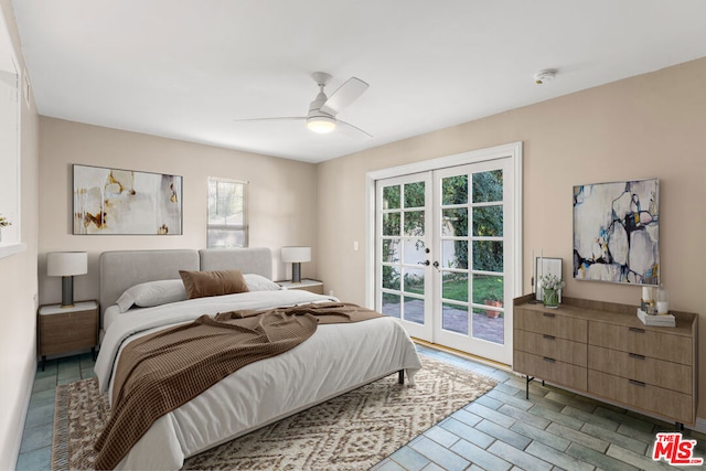 bedroom with access to outside, multiple windows, ceiling fan, and french doors