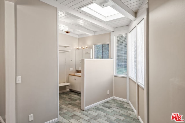 bathroom with beam ceiling and wood ceiling