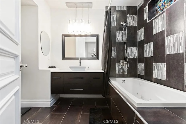 bathroom with vanity and tiled bath