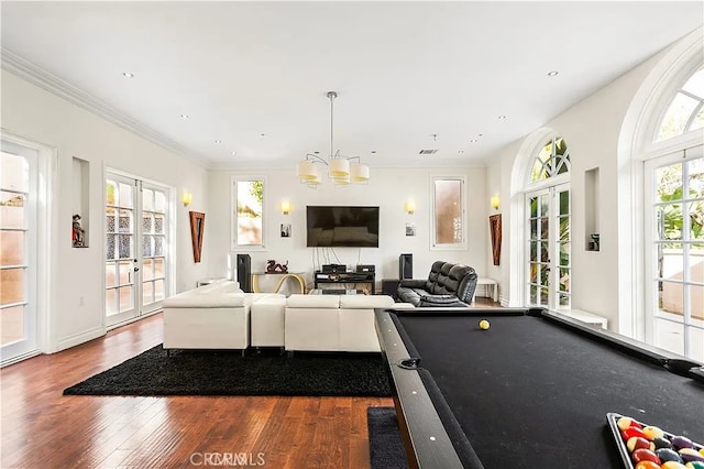 recreation room featuring french doors, dark hardwood / wood-style flooring, crown molding, a notable chandelier, and pool table