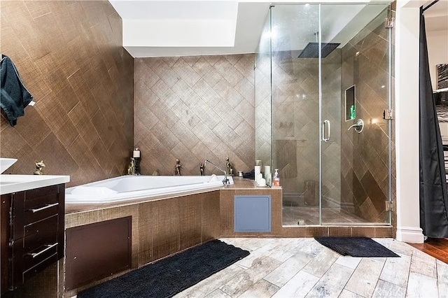 bathroom featuring vanity, separate shower and tub, and tile walls