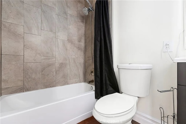 bathroom featuring shower / tub combo and toilet