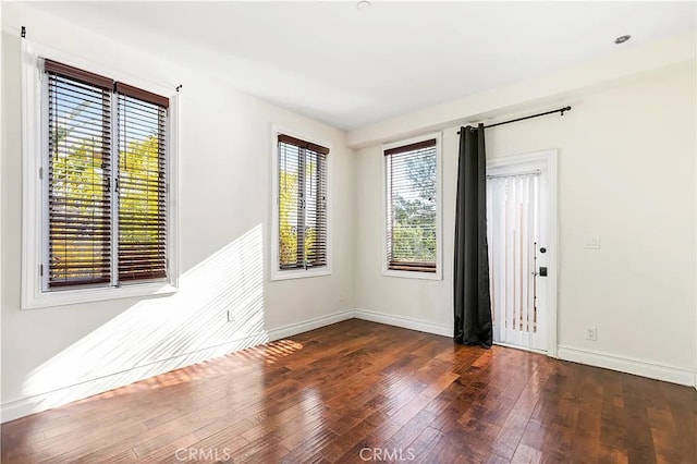 unfurnished room featuring dark hardwood / wood-style floors