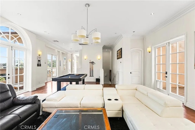 recreation room featuring ornamental molding, french doors, hardwood / wood-style floors, and a notable chandelier