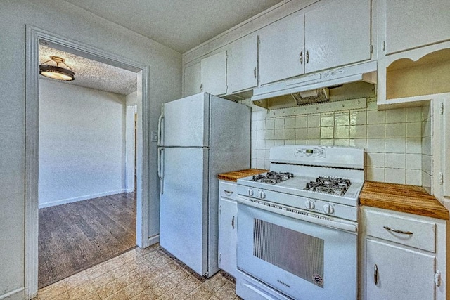 kitchen featuring white cabinetry, wooden counters, white appliances, and decorative backsplash