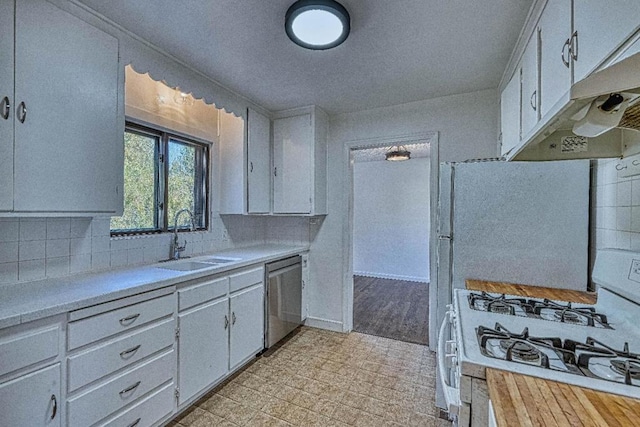 kitchen featuring white gas range, sink, stainless steel dishwasher, and white cabinets