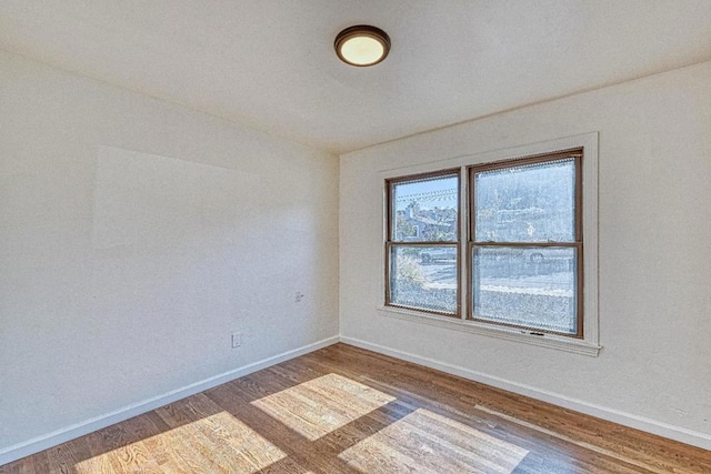 empty room with dark hardwood / wood-style flooring