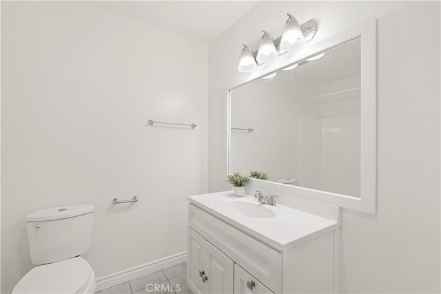 bathroom featuring tile patterned floors, vanity, and toilet