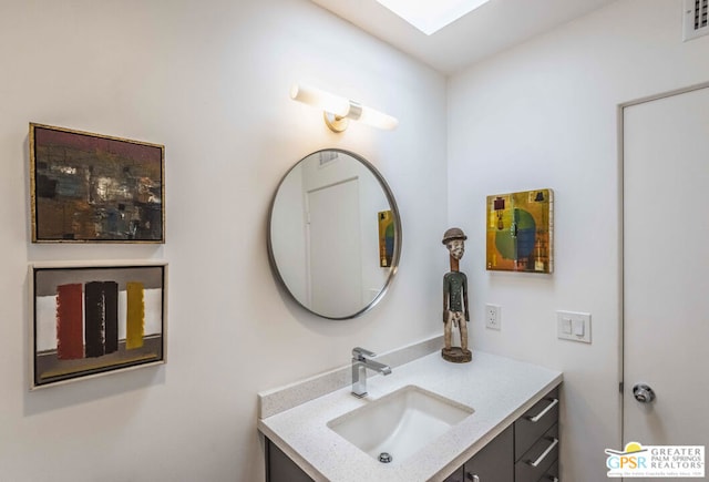 bathroom featuring vanity and a skylight