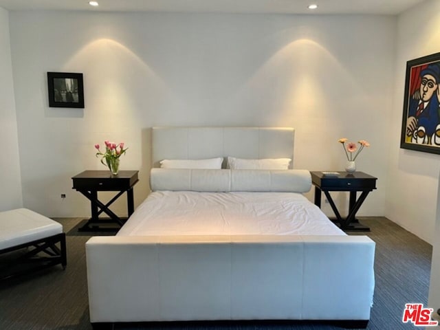 bedroom featuring dark colored carpet