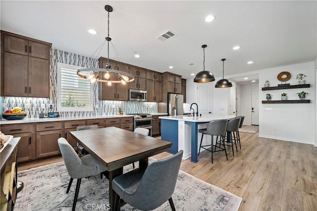 dining area featuring light hardwood / wood-style floors and sink