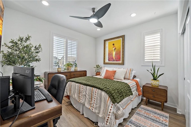 bedroom featuring wood-type flooring, a closet, and ceiling fan