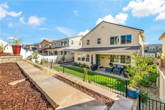 back of house with a patio area and an outdoor living space