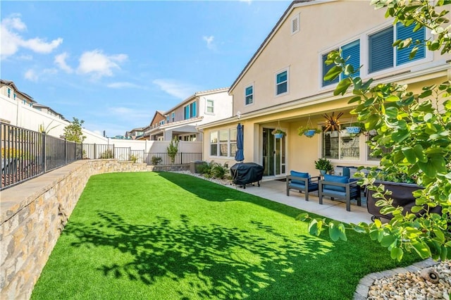 rear view of property featuring outdoor lounge area, a yard, and a patio area