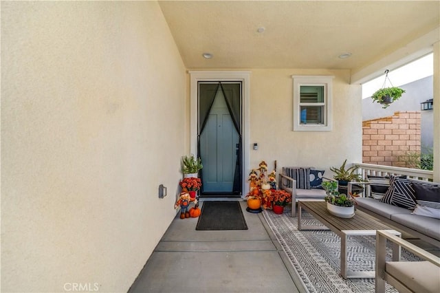 doorway to property with an outdoor living space