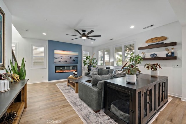 living room featuring ceiling fan and light wood-type flooring