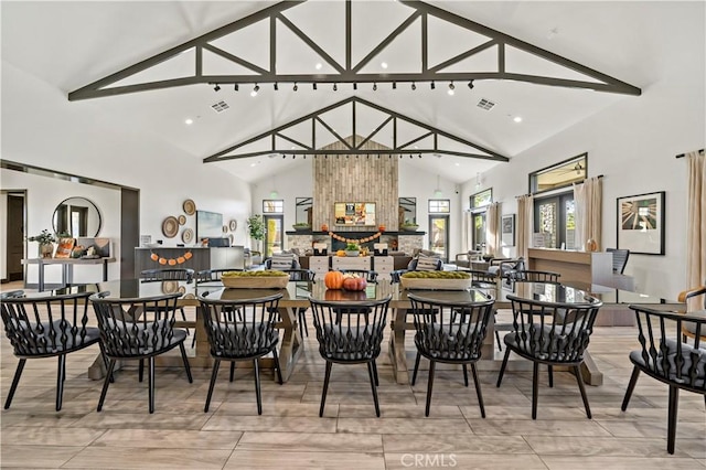 dining room with high vaulted ceiling