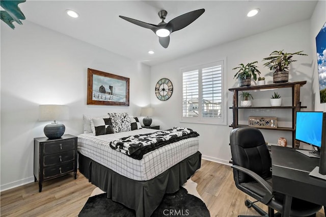 bedroom with ceiling fan and light hardwood / wood-style floors