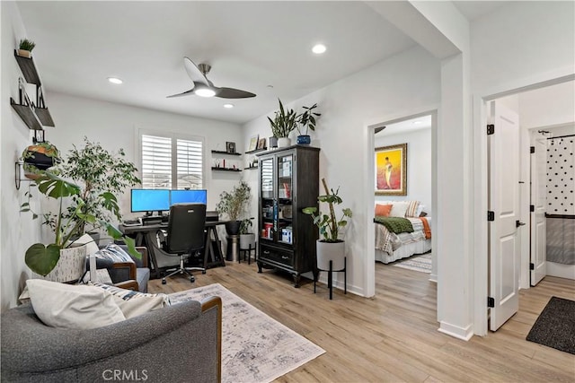 home office featuring ceiling fan and light hardwood / wood-style flooring