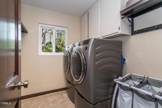 washroom featuring independent washer and dryer and cabinets