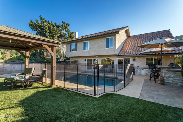 view of swimming pool featuring a gazebo, a yard, exterior bar, and a patio area