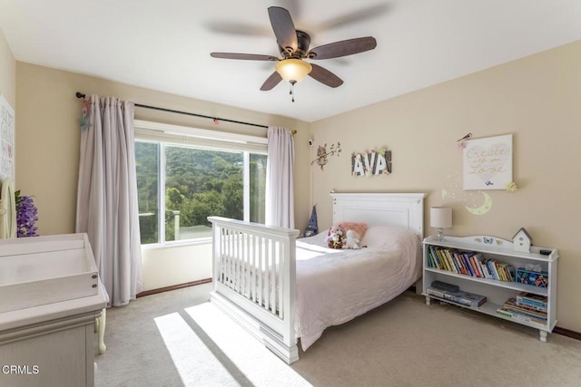 bedroom with light carpet and ceiling fan