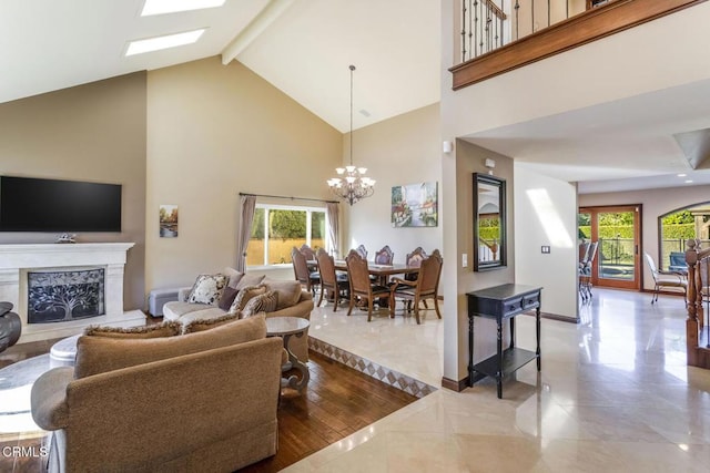 living room featuring a healthy amount of sunlight, high vaulted ceiling, a premium fireplace, and a chandelier