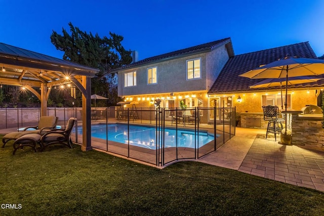 view of pool with a gazebo, a lawn, a patio, and exterior bar