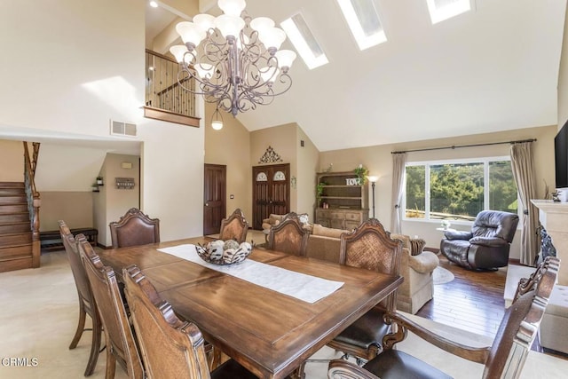 dining area with a chandelier and high vaulted ceiling