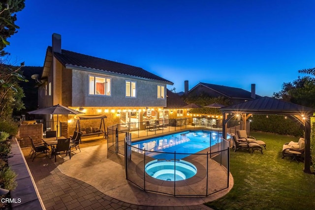 view of swimming pool featuring a yard, a gazebo, a patio area, and an in ground hot tub