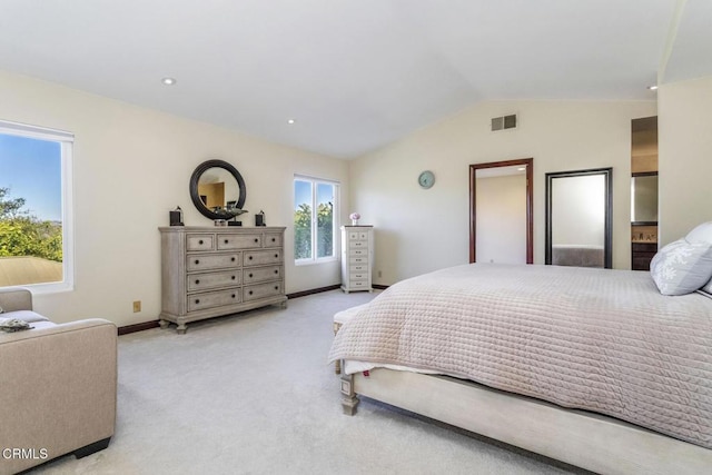 bedroom with lofted ceiling and light carpet