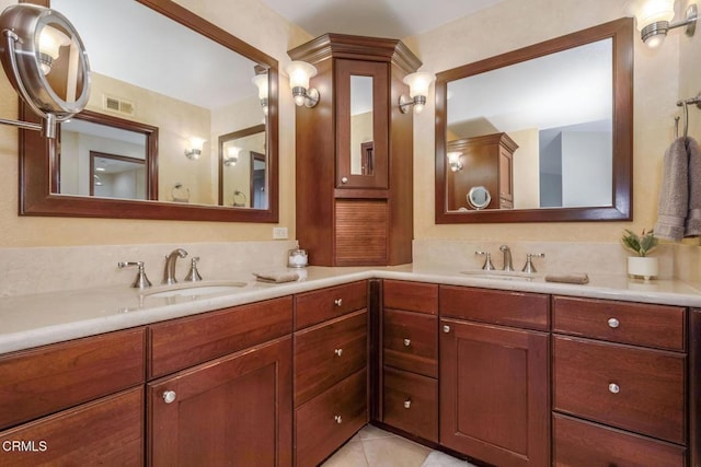 bathroom with tile patterned flooring and vanity