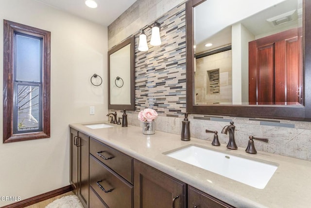 bathroom featuring vanity and decorative backsplash