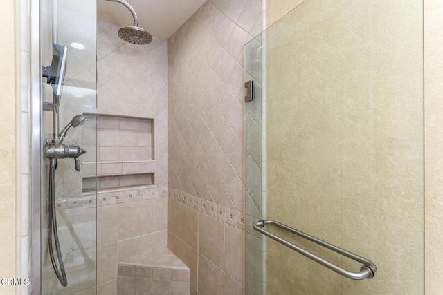 bathroom with a shower with door