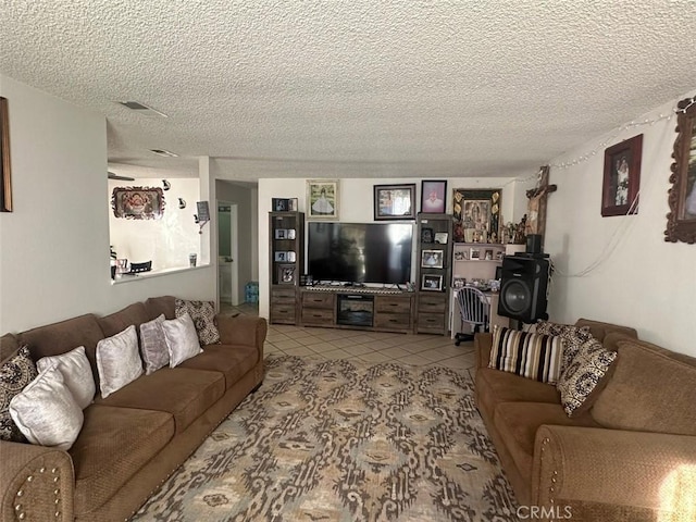 tiled living room featuring a textured ceiling