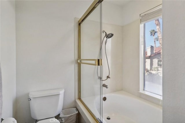 bathroom featuring toilet and enclosed tub / shower combo