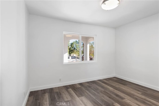 spare room with dark hardwood / wood-style flooring