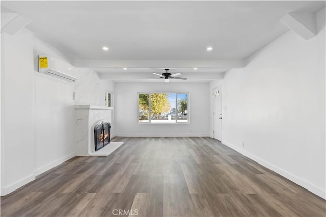 unfurnished living room with beam ceiling, dark hardwood / wood-style flooring, a wall mounted AC, and ceiling fan