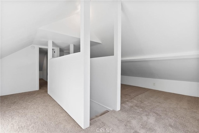 additional living space with light colored carpet and lofted ceiling