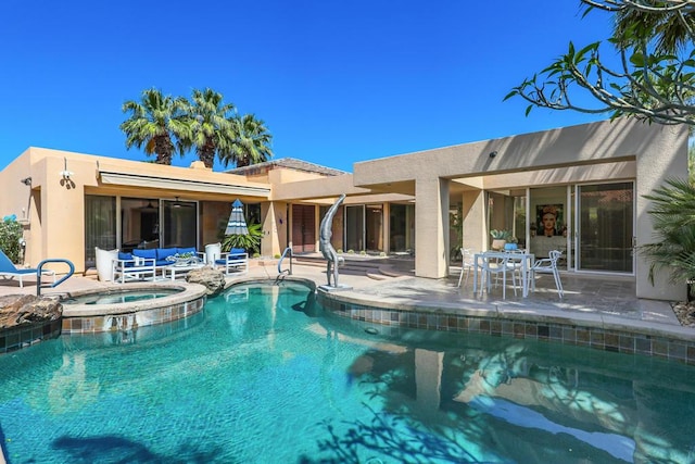 view of swimming pool with a patio area and an in ground hot tub