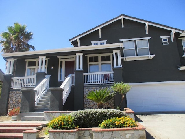 view of front of home with a porch and a garage