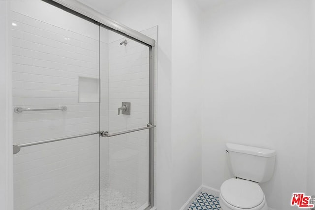 bathroom with toilet and walk in shower