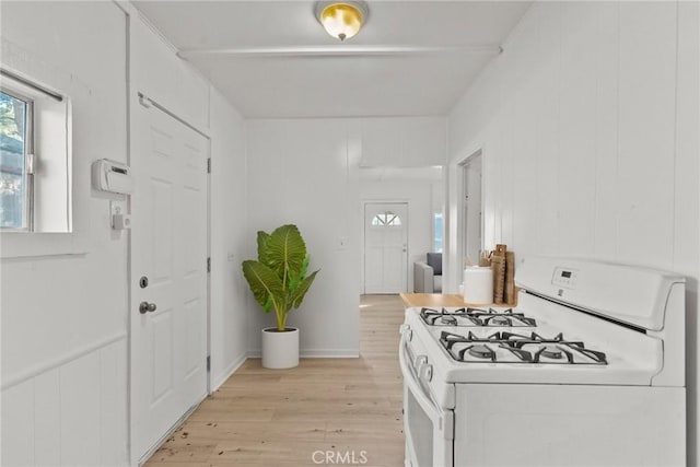 foyer entrance with wooden walls and light hardwood / wood-style flooring