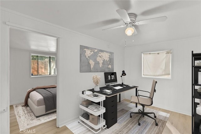 office area with ceiling fan, crown molding, and wood-type flooring