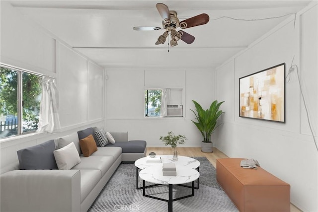 living room with ceiling fan, cooling unit, and light wood-type flooring